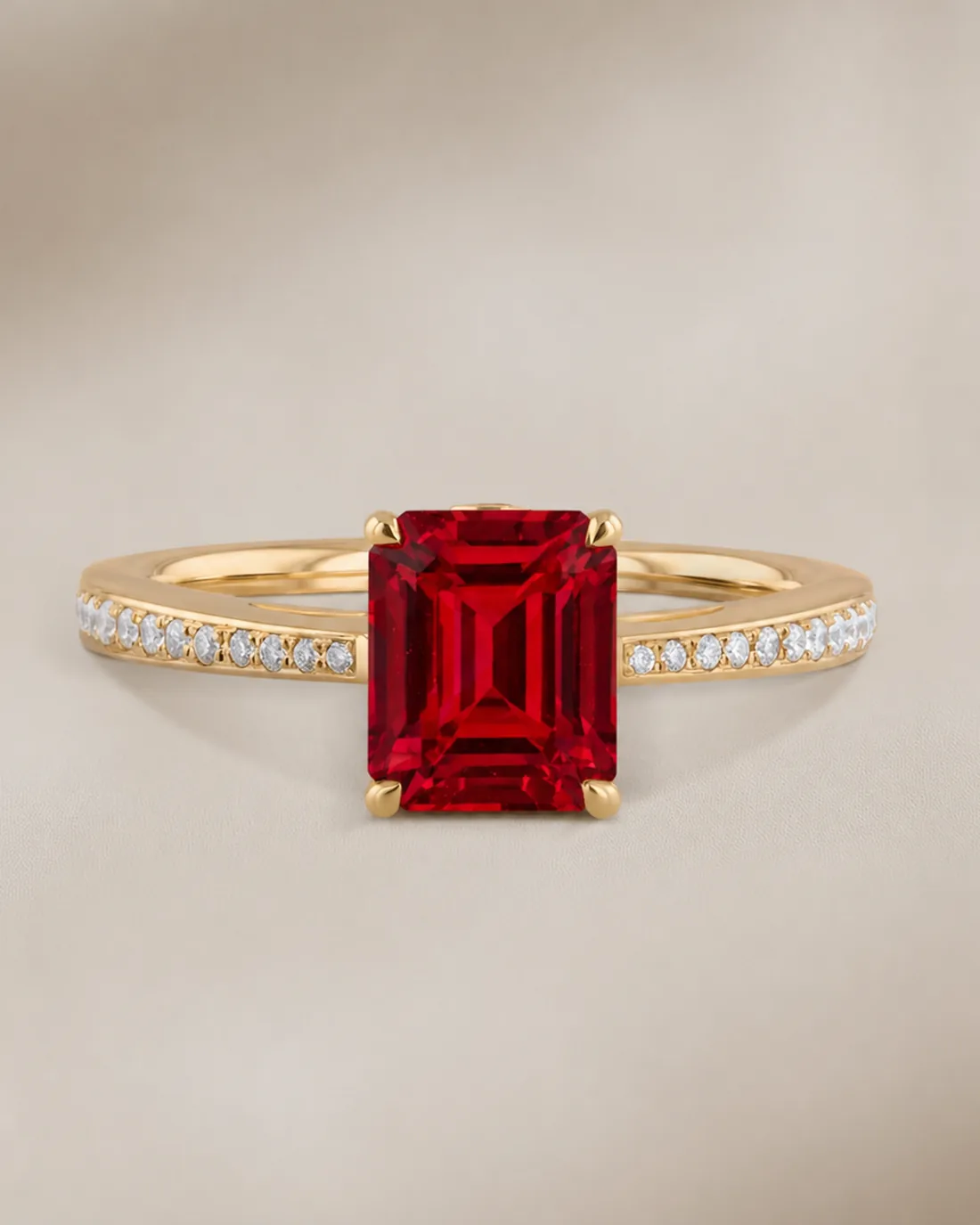 Close work at the bench: diamond pavé hand-set around an emerald-cut ruby